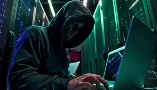Image of a hacker, hacking from his laptop