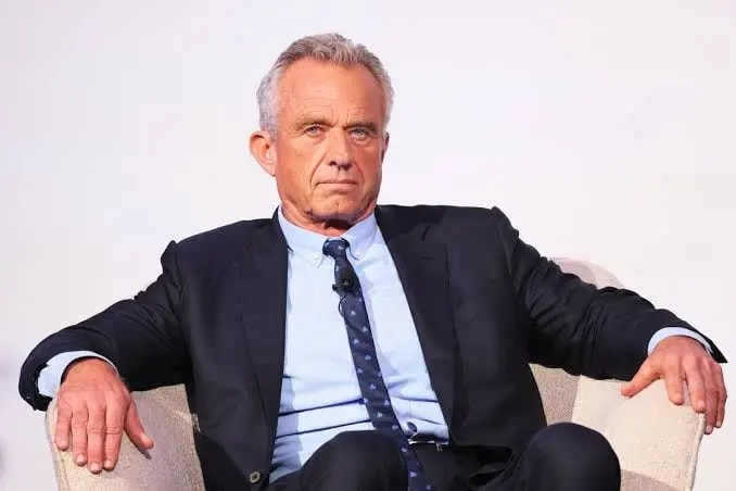 Image of Robert F. Kennedy Jr. wearing white shirt, tie and a black coat